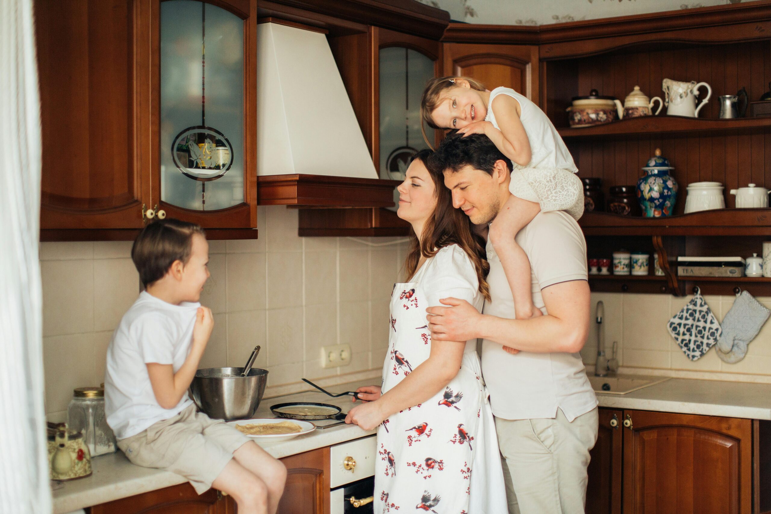 A family in the kitchen of a home their loan helped them buy